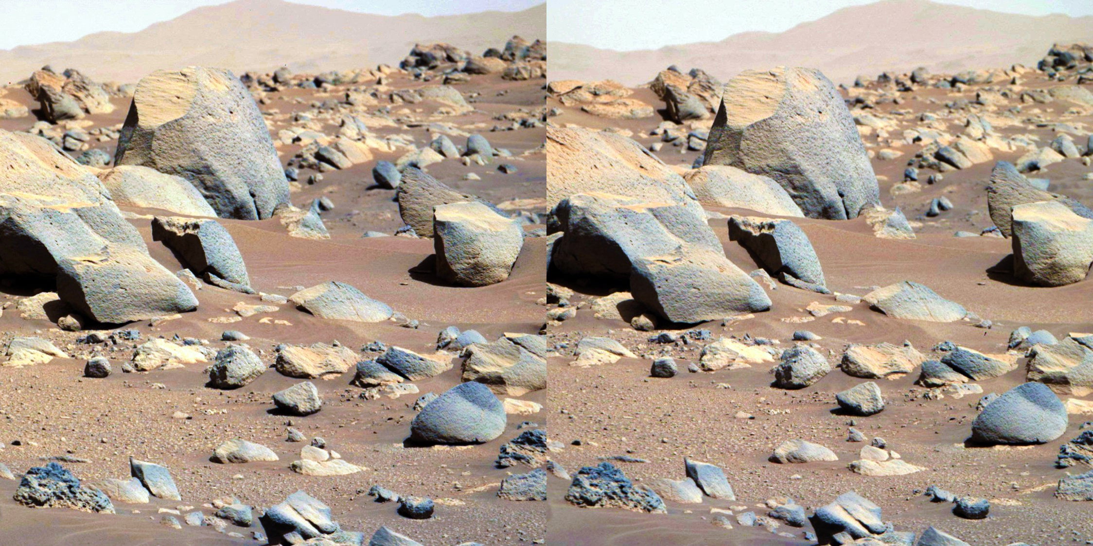 The medium of stereoscopic 3D allows the viewer to perceive the various depth layers within the scene. Here, a large quantity of rocks of different shapes and sizes extends over a vast area. 