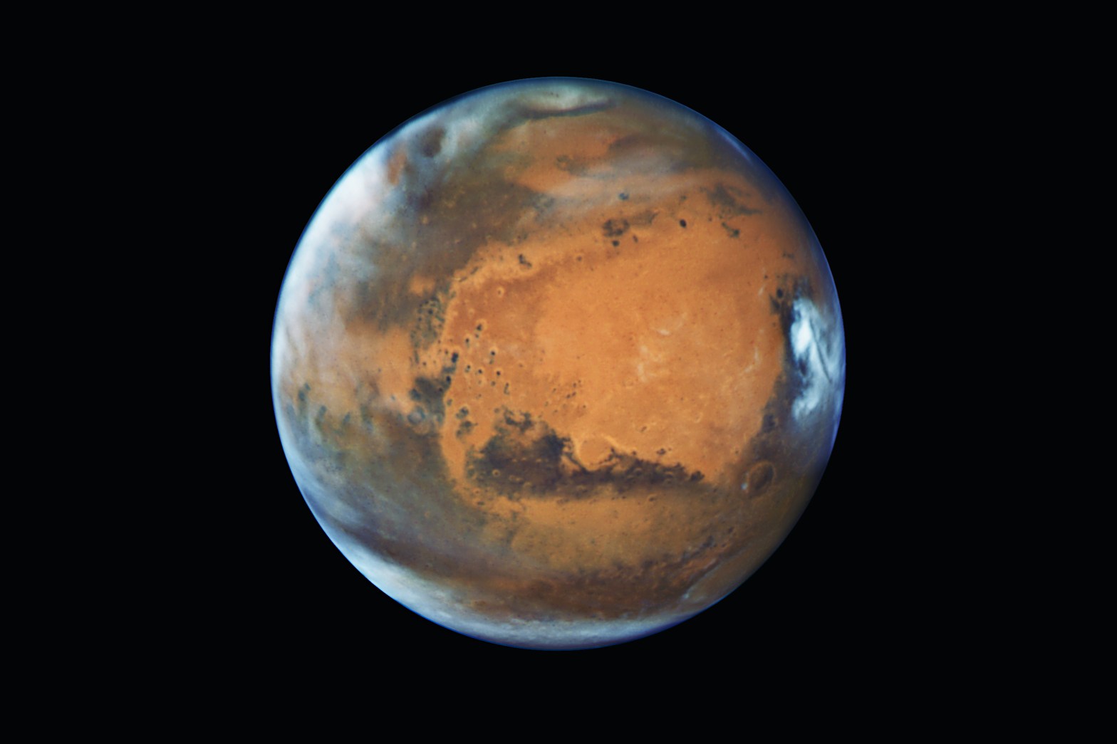 Mars is a dynamic world that continues to intrigue us. This image, captured by the Hubble Space Telescope, shows the planet wreathed in late-afternoon clouds.