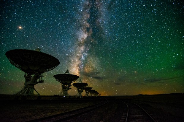 Dishes of the Karl G. Jansky Very Large Array in New Mexico line up beneath the starry sky. Radio waves are just one of the numerous signals from space that comprise the soundtrack of the cosmos.