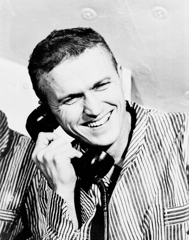 Frank Borman takes a phone call from President Lyndon Johnson.