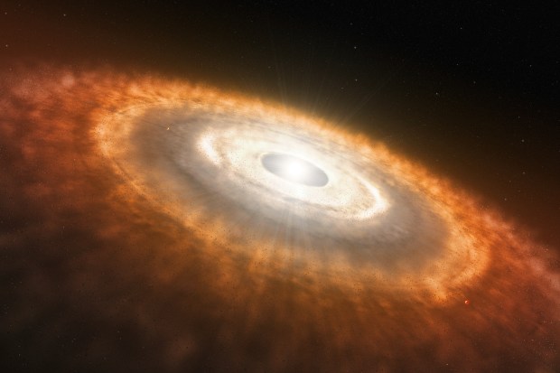 An artists representation of a Protoplanetary Disk. The disk's outer rings are orange while the middle is a bright ball of light.