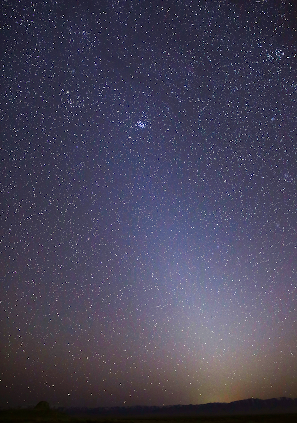 From very dark locations, the zodiacal light may appear to extend up through the Pleiades in Taurus.
