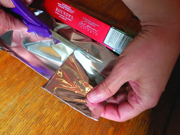 Step 5: Cut out a piece of aluminum foil (I used a fairly thick variety) big enough to cover the hole in the box.
