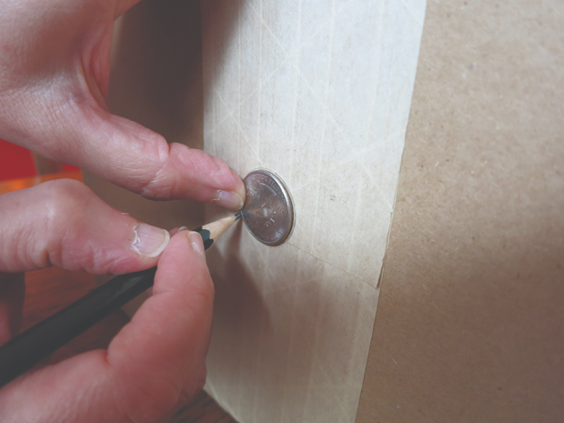 Step 2 in wow to make a pinhole viewer is to trace a quarter on one of the box's smaller ends.