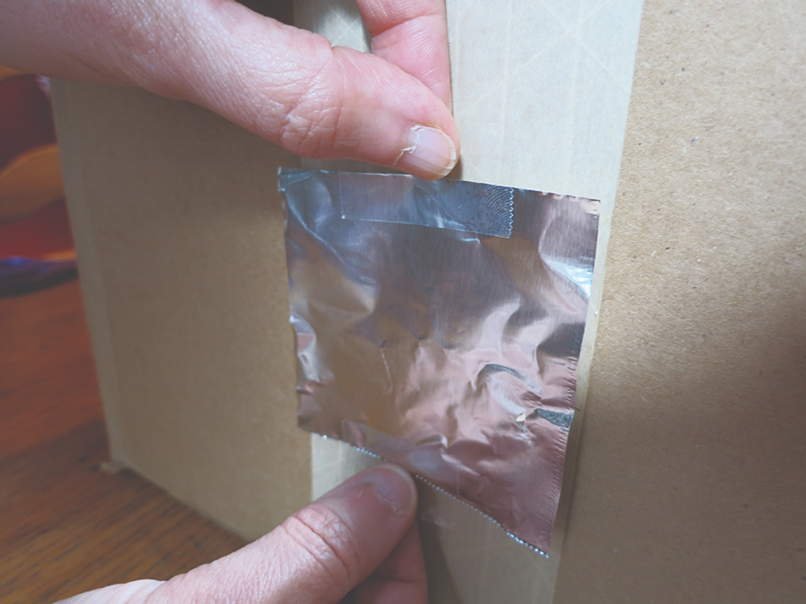 Step 6: Tape the foil over the hole.