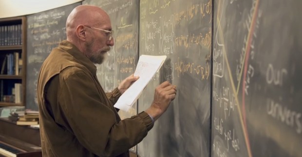 Kip Thorne works at a blackboard in a screenshot taken from a promotional video for Interstellar.