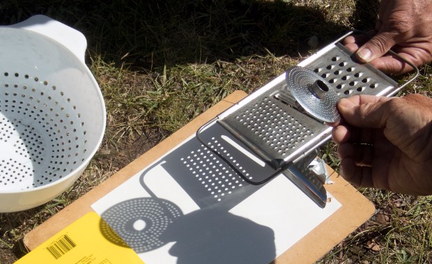 Kitchen utensils with holes — like colanders and graters — can become makeshift pinhole projectors.