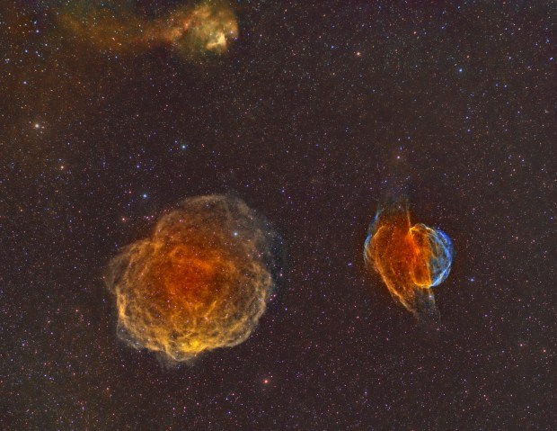 Three nebulae in shades of orange and blue.