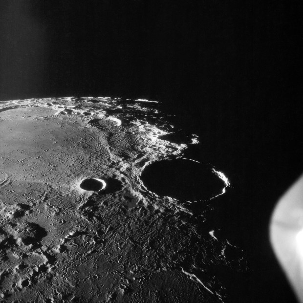 An Apollo 11 oblique view of the large crater Theophilus located at the northwest edge of the Sea of Nectar on the lunar nearside. Theophilus is about 60 statute miles in diameter. The smooth area is Mare Nectaris. The smaller crater Madler, about 14 statute miles in diameter, is located to the east of Theophilus. Visible in the background are the large crater Fracastorius and the smaller crater Beaumont. This photo was taken July 16, 1969. Credit: NASA.
