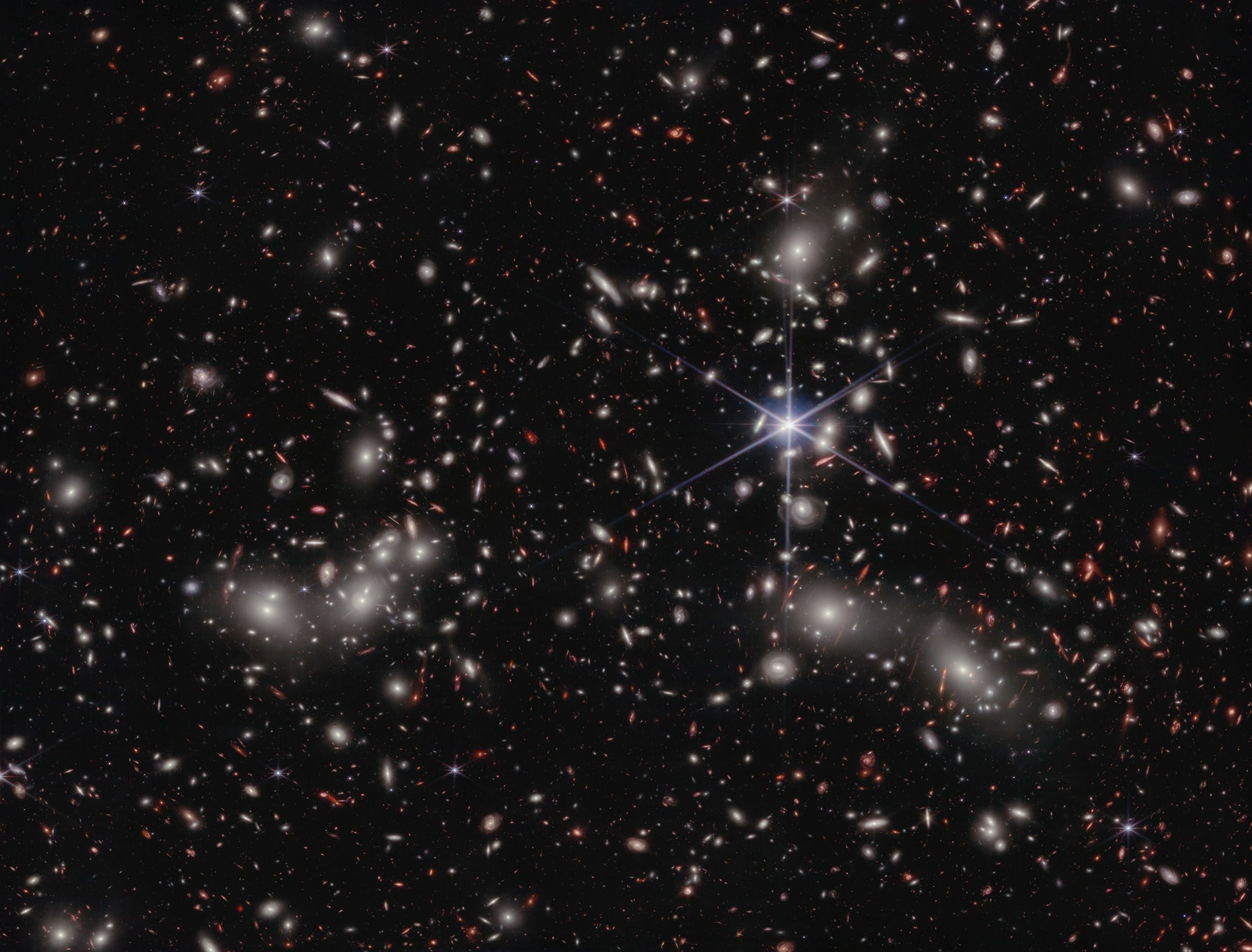 Astronomers estimate 50,000 sources of near-infrared light are represented in this image from NASA’s James Webb Space Telescope. A foreground star in our own galaxy, to the right of the image center, displays Webb’s distinctive diffraction spikes. Bright white sources surrounded by a hazy glow are the galaxies of Pandora’s Cluster, a conglomeration of already-massive clusters of galaxies coming together to form a megacluster. Credit: NASA, ESA, CSA, Ivo Labbe (Swinburne), Rachel Bezanson (University of Pittsburgh), Alyssa Pagan (STScI).