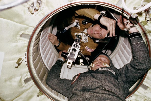 Stafford and Cosmonaut Aleksei A. Leonov aboard Soyuz in the hatchway leading from the Apollo Docking Module (DM) to the Soyuz Orbital Module in 1975. Credit: NASA.