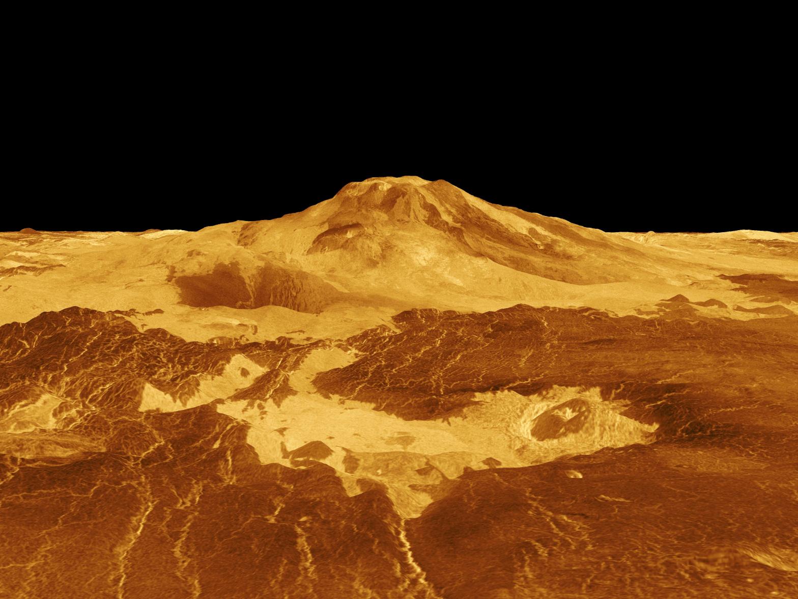 A volcano towers over its surroundings, the terrain shown in false-color yellows and oranges.