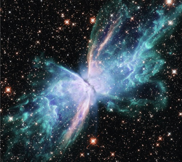 The "Butterfly Nebula" imaged by the Hubble Space Telescope. Per NASA, "the star or stars at its center are responsible for the nebula's appearance. In their death throes, they have cast off layers of gas periodically over the past couple thousand years. The 'wings' of NGC 6302 are regions of gas heated to more than 36,000 degrees Fahrenheit that are tearing across space at more than 600,000 miles an hour."