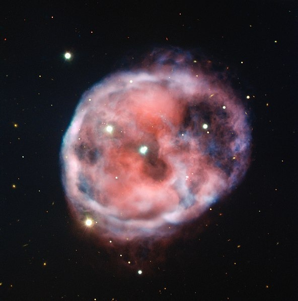 Captured in astounding detail by ESO’s Very Large Telescope (VLT), the eerie Skull Nebula is showcased in this image in beautiful pink and red tones. This planetary nebula, also known as NGC 246, is the first known to be associated with a pair of closely bound stars orbited by a third outer star.