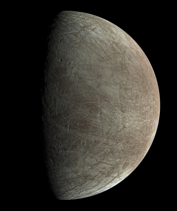 Europa was captured by JunoCam, during the mission's close flyby on Sept. 29, 2022. The circular dark feature at the lower right is Callanish Crater.