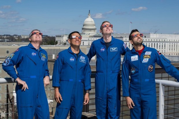 Never look directly at the Sun unless you wear proper eye protection, like this picture of astronauts in Washington DC with eclipse glasses.