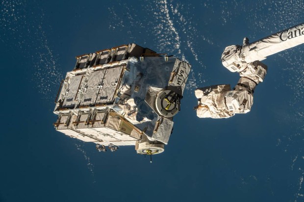 An external pallet packed with old nickel-hydrogen batteries is pictured shortly after mission controllers in Houston commanded the Canadarm2 robotic arm to release it into space.