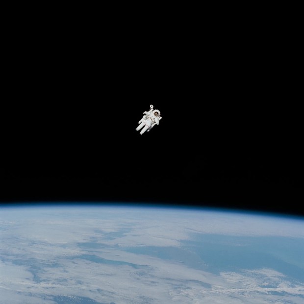 Astronaut Bruce McCandless II approaches his maximum distance from the Earth-orbiting Space Shuttle Challenger in this 70mm photo from Feb. 7, 1984.