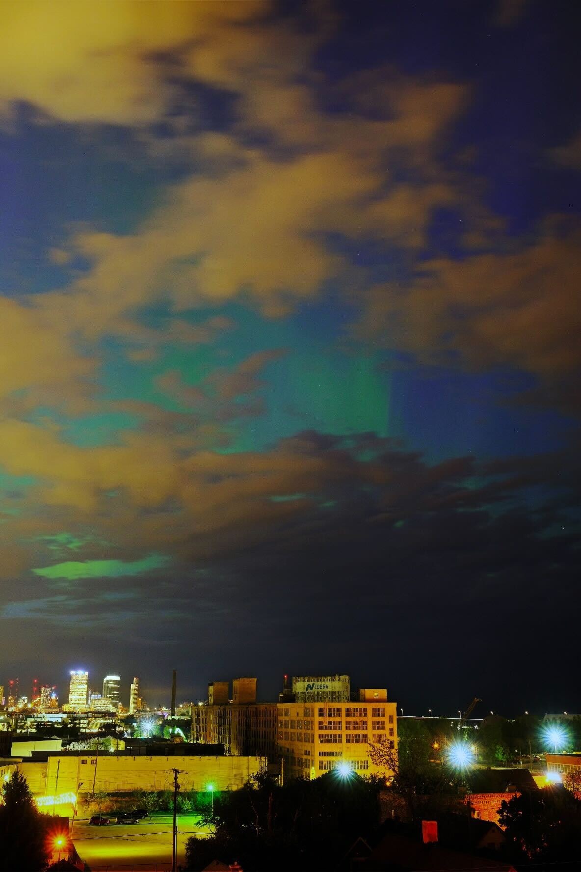 The northern lights over Milwaukee, seen through clouds.