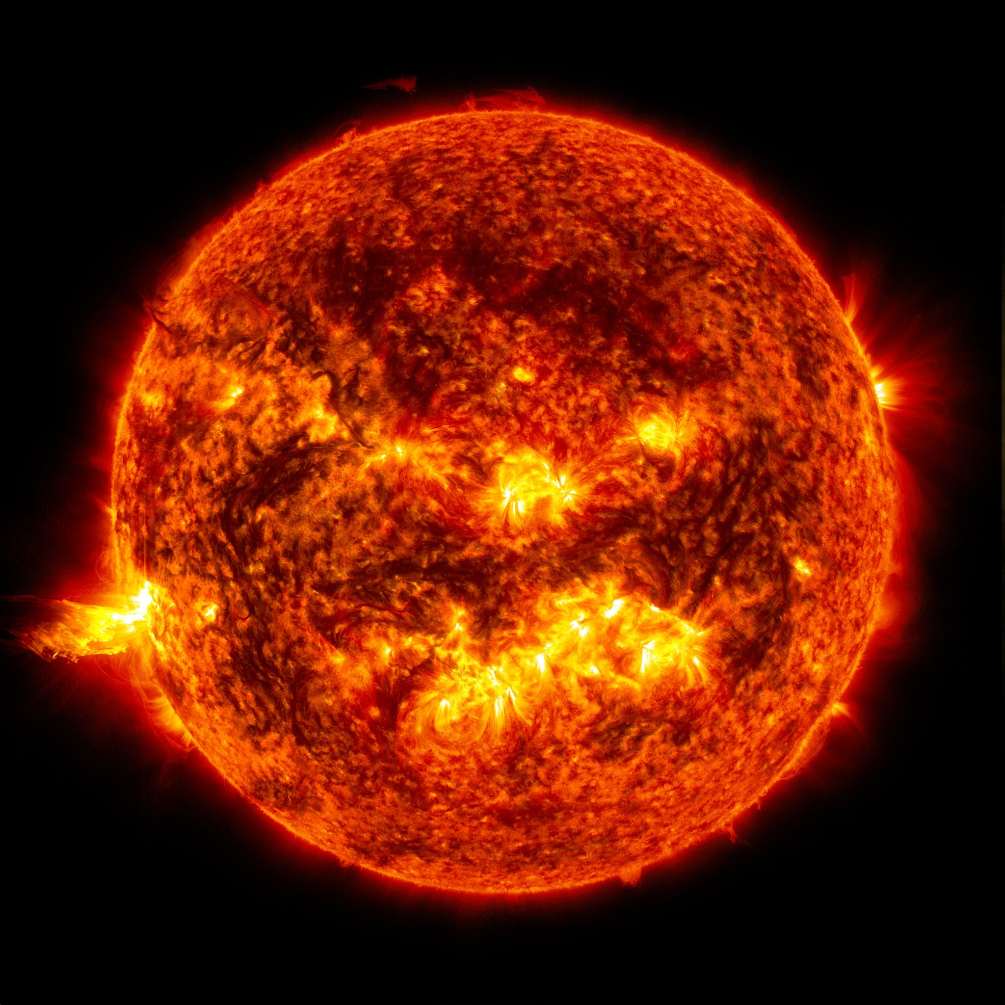 This image from 2013 shows the bright light of a solar flare on the left side of the sun and an eruption of solar material shooting through the sun’s atmosphere, called a prominence eruption. Credit: NASA/Goddard/SDO.